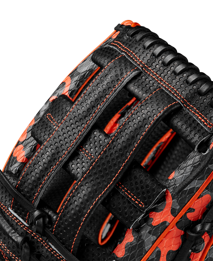 Close-up of the limited edition Wilson A2000 SC1777SS 12.75" Baseball Glove (GOTM Oct 2024), crafted from Pro Stock leather with black and orange camo, orange stitching, and detailed woven lacing. Model: WBW1027911275.