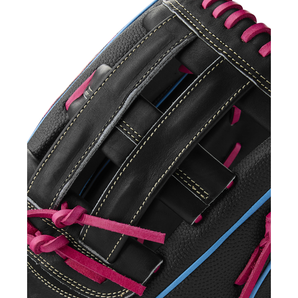 Close-up of the Wilson A2000 1777SS 12.75" Baseball Glove (Summer 2025), WBW1032221275, in black leather with pink laces, yellow stitching, blue piping, SuperSkin material, and a woven web design showcasing its detailed craftsmanship.