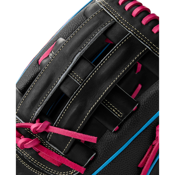 Close-up of the Wilson A2000 1777SS 12.75" Baseball Glove (Summer 2025), WBW1032221275, in black leather with pink laces, yellow stitching, blue piping, SuperSkin material, and a woven web design showcasing its detailed craftsmanship.