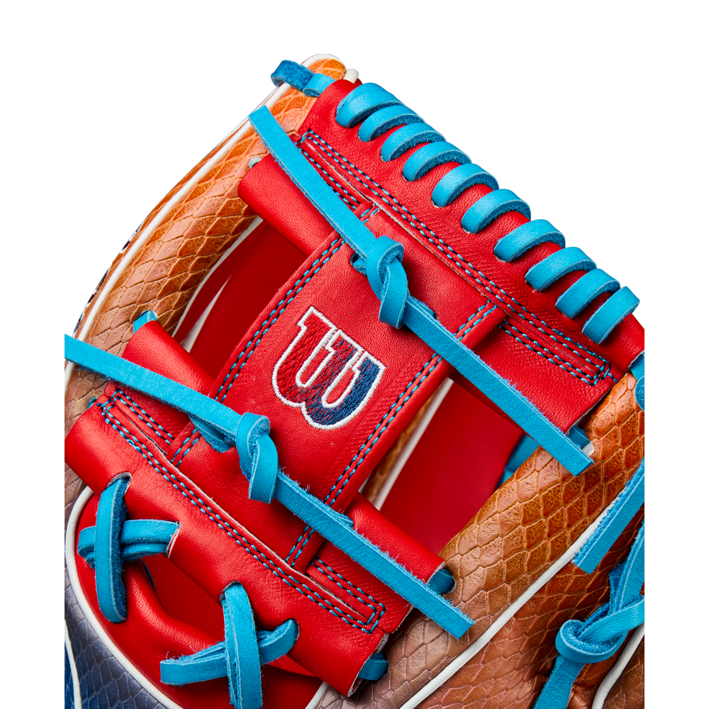 Close-up of the Wilson A2K 1786SS 11.5" Baseball Glove (WBW103290115), showcasing brown, red, and blue leather with blue laces, SuperSnakeSkin accents, and the Wilson W logo on a bold red panel.