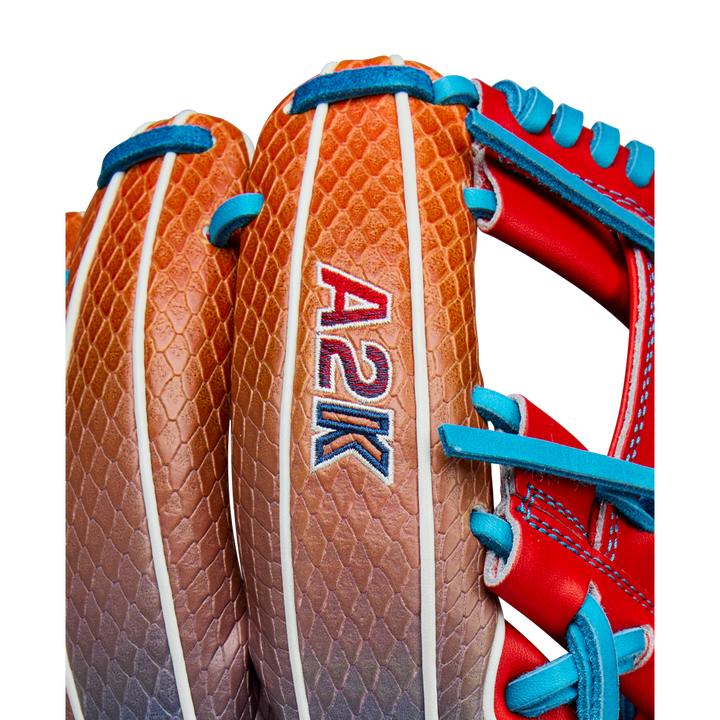 Close-up of the Wilson A2K 1786SS 11.5" Baseball Glove (WBW103290115) with a brown and tan textured design, SuperSnakeSkin accents, and blue and red laces, released for Summer 2025.