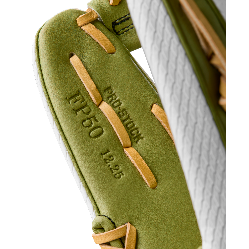 Close-up of the Wilson A2000 FP50SS 12.25" Fastpitch Glove with beige laces, made from Pro Stock leather and featuring "PRO STOCK," "IFP50," and "12.25" embossed on the palm. Model: WBW1033001225. Summer 2025 release.