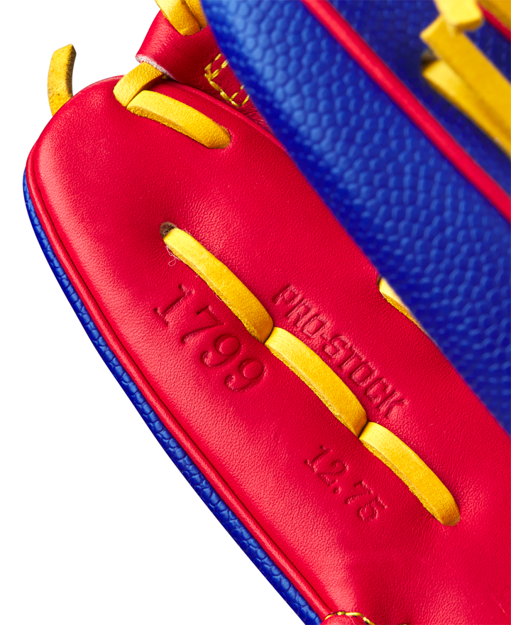 Close-up of the red leather interior and yellow laces of the Wilson A2000 1799SS 12.75" Pete Crow-Armstrong GM Baseball Glove (GOTM Jan 2025), featuring embossed 1799 and 12.75 with partially visible PRO STOCK text.