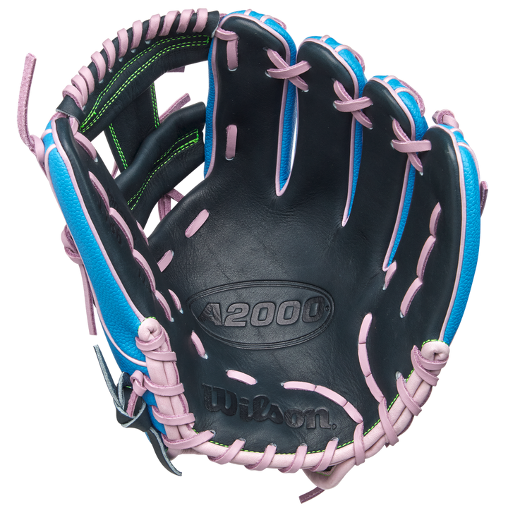 The Wilson A2000 1786SS 11.5" Baseball Glove (GOTM March 2025, WBW103479115) features durable Pro Stock leather, a black palm, blue shell, pink laces, green stitching accents, and an embossed Wilson logo inside.