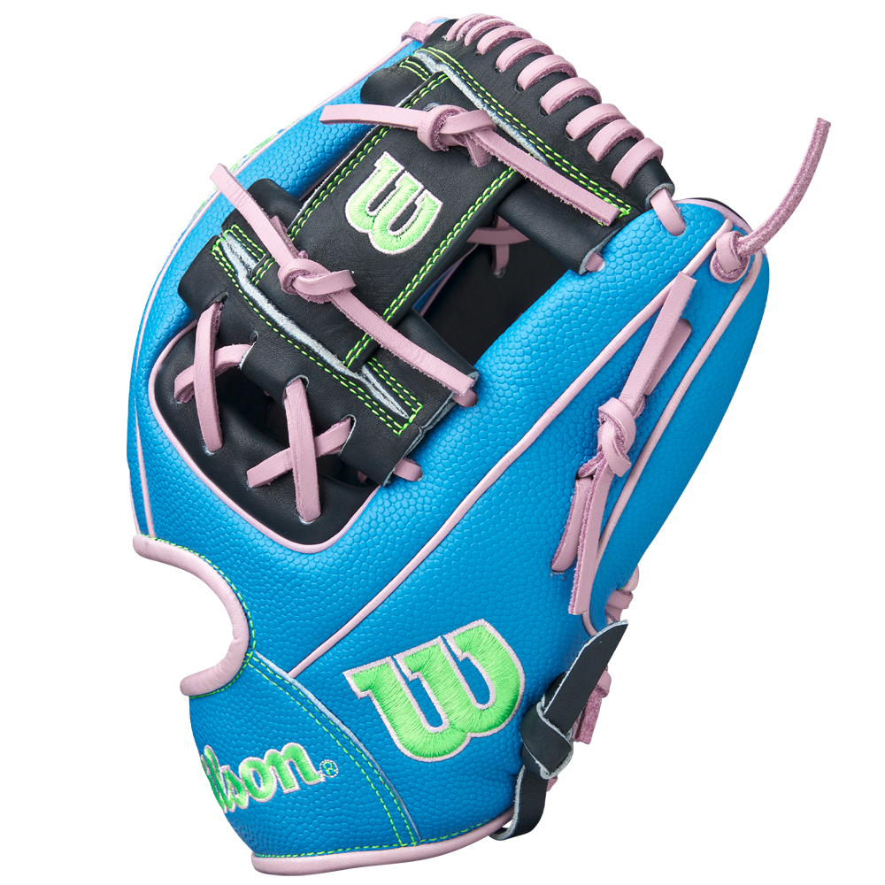 The Wilson A2000 1786SS 11.5" Baseball Glove (GOTM March 2025, WBW103479115) features a blue design with black, green, and pink accents, pink laces, green W logos, Pro Stock leather, and is shown upright on a white background.