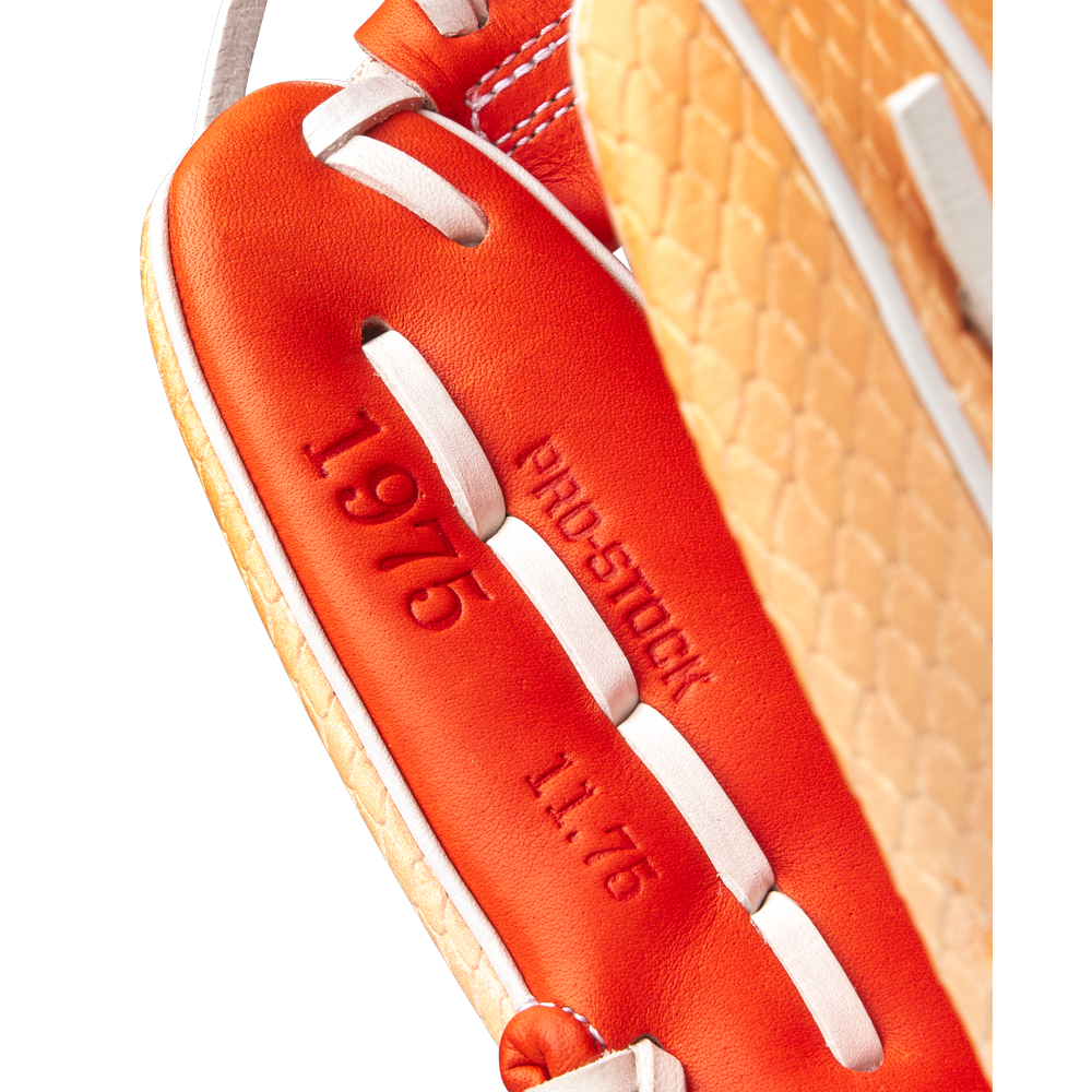 Close-up of a Wilson A2000 1975SS 11.75" Baseball Glove (GOTM June 2025, WBW1034811175) in orange and tan, featuring embossed PRO-STOCK 1975 text and white laces on premium Pro Stock leather.