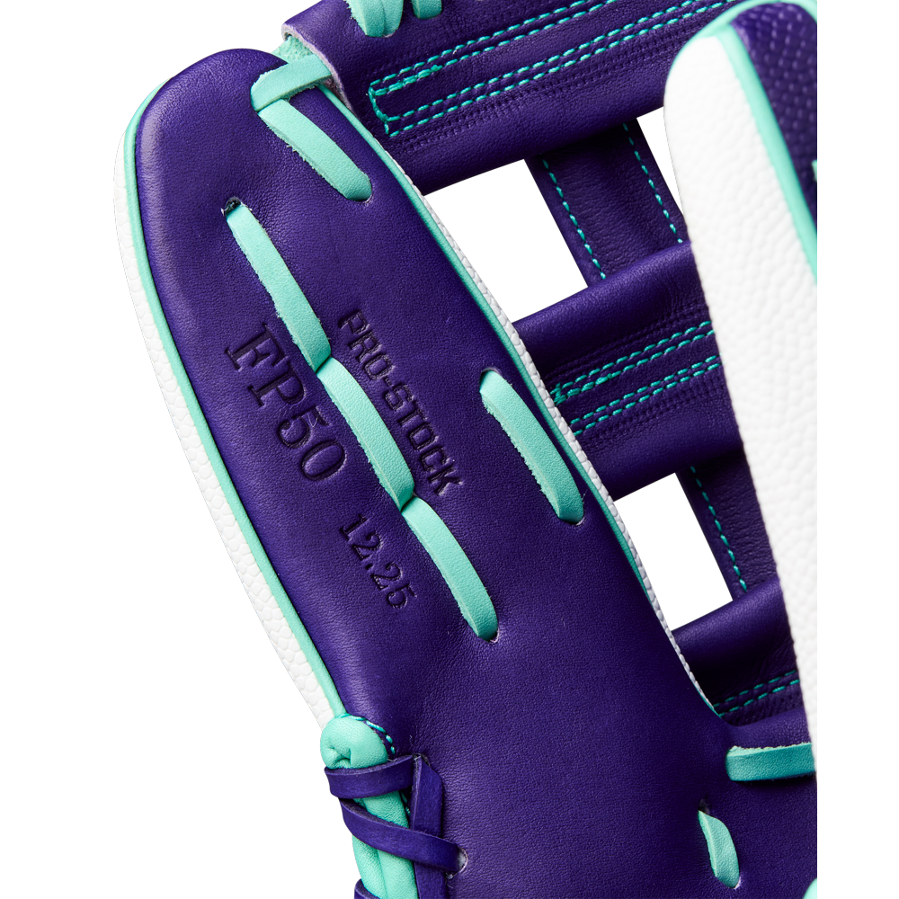 Close-up of the Wilson A2000 FP50SS 12.25" Fastpitch Glove, FALL 2025 (WBW1034891225) in purple and teal with white stitching, featuring PRO STOCK, IFP50, and L2.25 embossed on premium Pro Stock leather.
