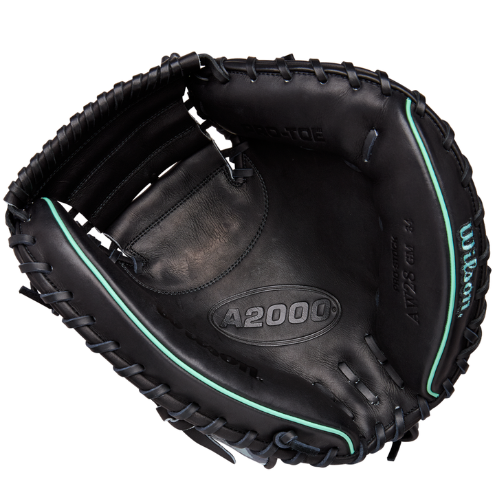 The Wilson A2000 AW28 34" Austin Wells Gameday Catcher's Mitt (FALL 2025: WBW10349434) by Wilson features a black design with teal accents and visible laces, shown open with the palm and pocket facing up—just like Austin Wells uses.