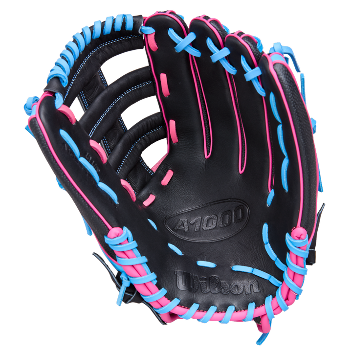 The Wilson A1000 1892 12.25" Baseball Glove (WBW1039621225) by Wilson is a black outfield glove with bright blue and pink laces and stitching, made from Full Grain leather, shown open with the palm up against a white background.