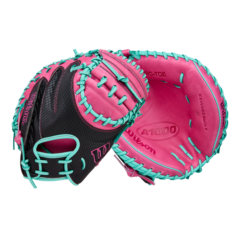 The Wilson A1000 CM33 33" Baseball Catcher's Mitt (WBW10396633) by Wilson features a black design with bright pink palm and teal blue lacing, crafted from full grain leather—ideal for youth catchers. Shown front and back on white background.