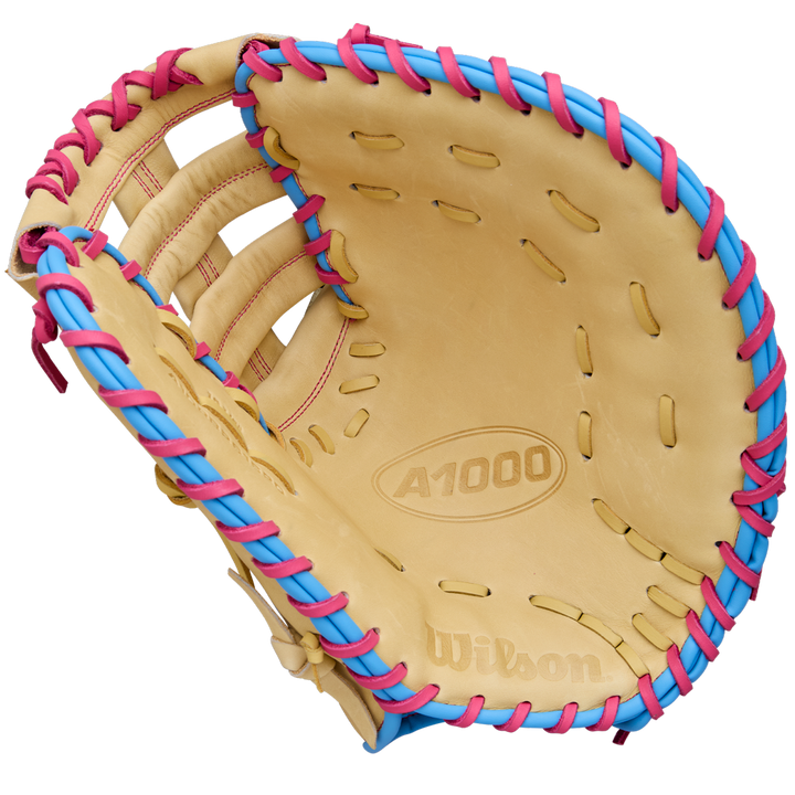 A Wilson A1000 1620 12.5" Baseball First Base Mitt (WBW103967125) by Wilson, shown open with palm and webbing visible against a white background, features full grain leather and blue and pink laces.
