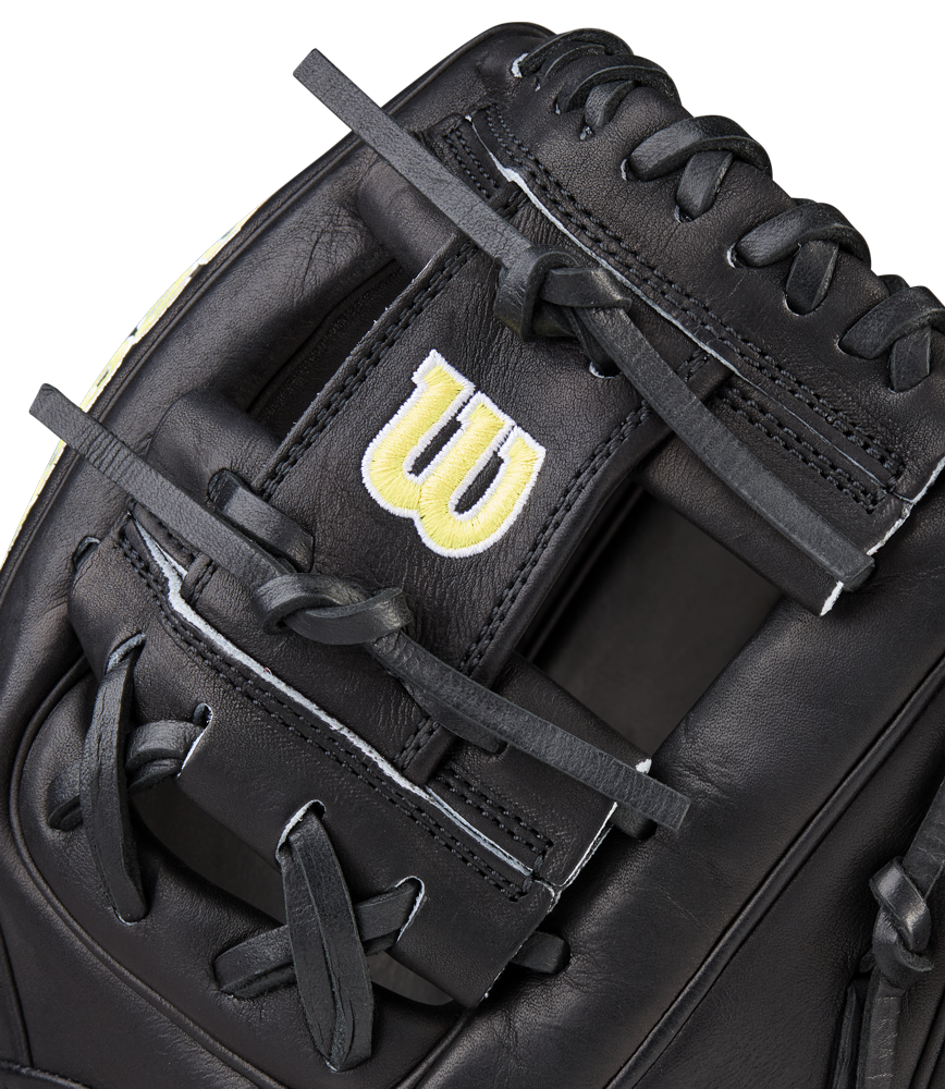 Close-up of a Wilson A2000 1788 11.25" baseball glove, crafted from black Pro Stock Leather with black laces and a yellow embroidered W logo on a strap near the webbing.
