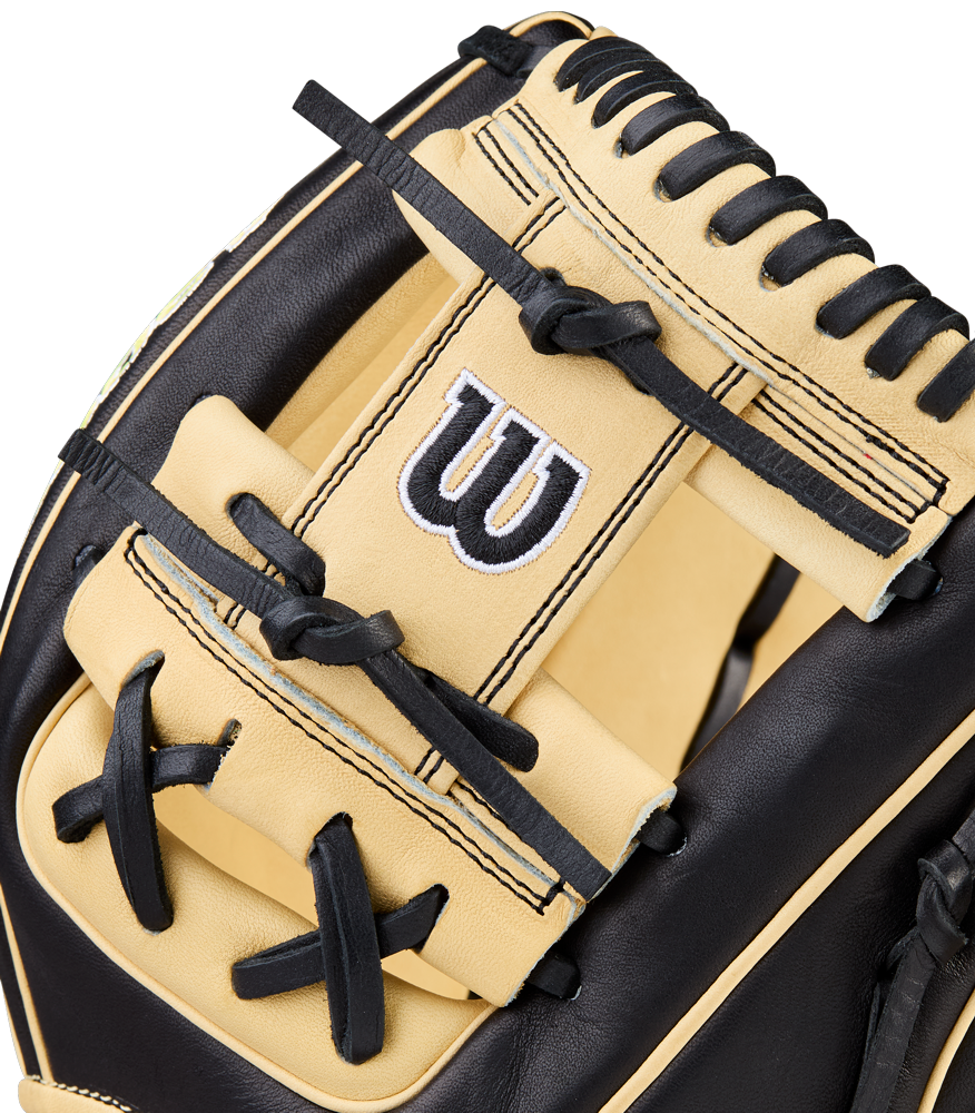 Close-up of the Wilson A2000 1786 11.5" Baseball Glove, featuring Pro Stock Leather in beige and black, detailed stitching, black laces, H-Web design, and a white “W” logo embroidered on the back.