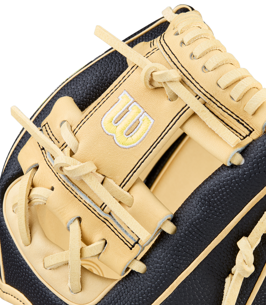 A close-up of the Wilson A2000 DP15SS 11.5" Baseball Glove showcases tan and black leather, bold stitching, SuperSkin accents, a prominent Wilson W logo, and quality craftsmanship throughout.