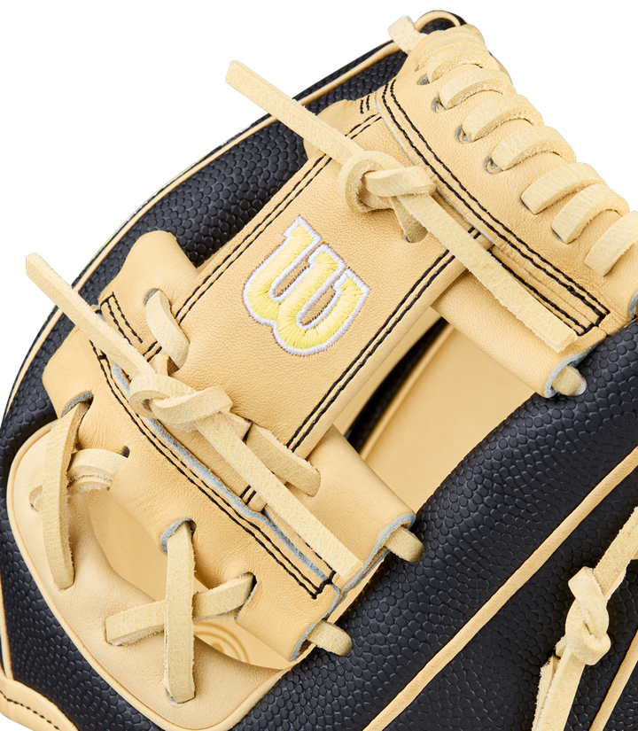 A close-up of the Wilson A2000 DP15SS 11.5" Baseball Glove showcases tan and black leather, bold stitching, SuperSkin accents, a prominent Wilson W logo, and quality craftsmanship throughout.