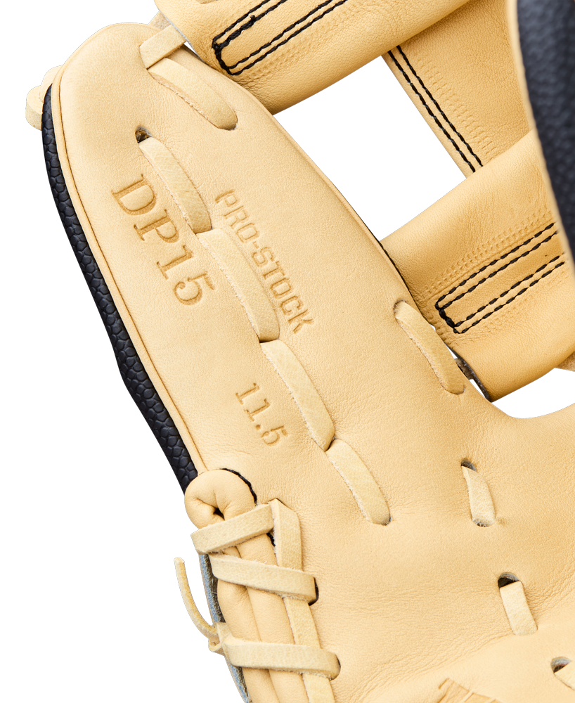 Close-up of the Wilson A2000 DP15SS 11.5" baseball glove (WBW104110115) featuring tan leather, black laces, detailed stitching, embossed "DP15 PRO STOCK 11.5" text, and Pedroia Fit Technology for a secure, comfortable fit.
