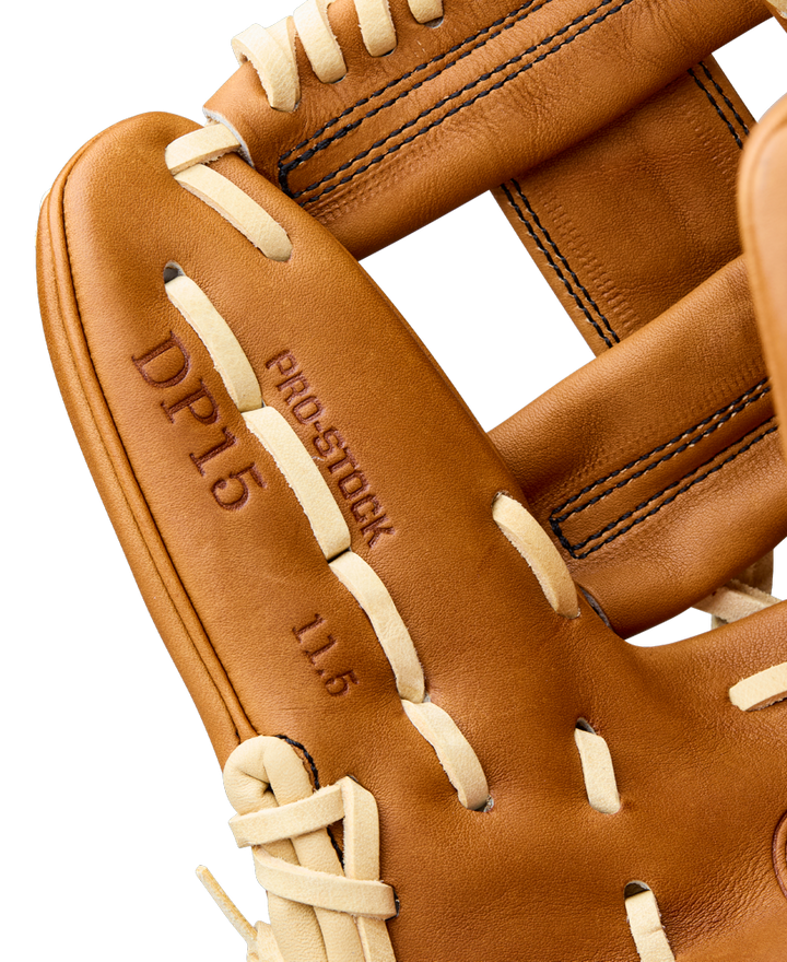 Close-up of the Wilson A2000 DP15 11.5" Baseball Glove (WBW104111115) by Wilson, featuring cream laces, tan Pro Stock leather with DP15 and 11.5 embossed, Pedroia Fit design, and detailed visible stitching.