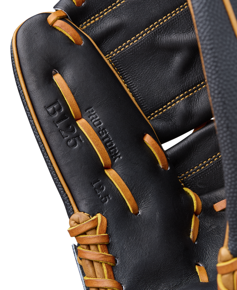 Close-up of the Wilson A2000 B125SS 12.5" Baseball Glove (WBW104119125), featuring black leather with yellow-orange laces, visible stitching, SuperSkin material, and embossed B125 and PRO STOCK on the palm.