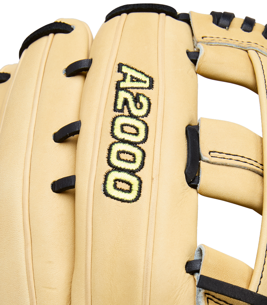 A close-up of the Wilson A2000 1777 12.75" Baseball Glove (WBW1041231275) shows its tan Pro Stock leather, black laces, and A2000 logo embroidered in yellow and black on the back, highlighting Wilson’s premium outfield glove design.