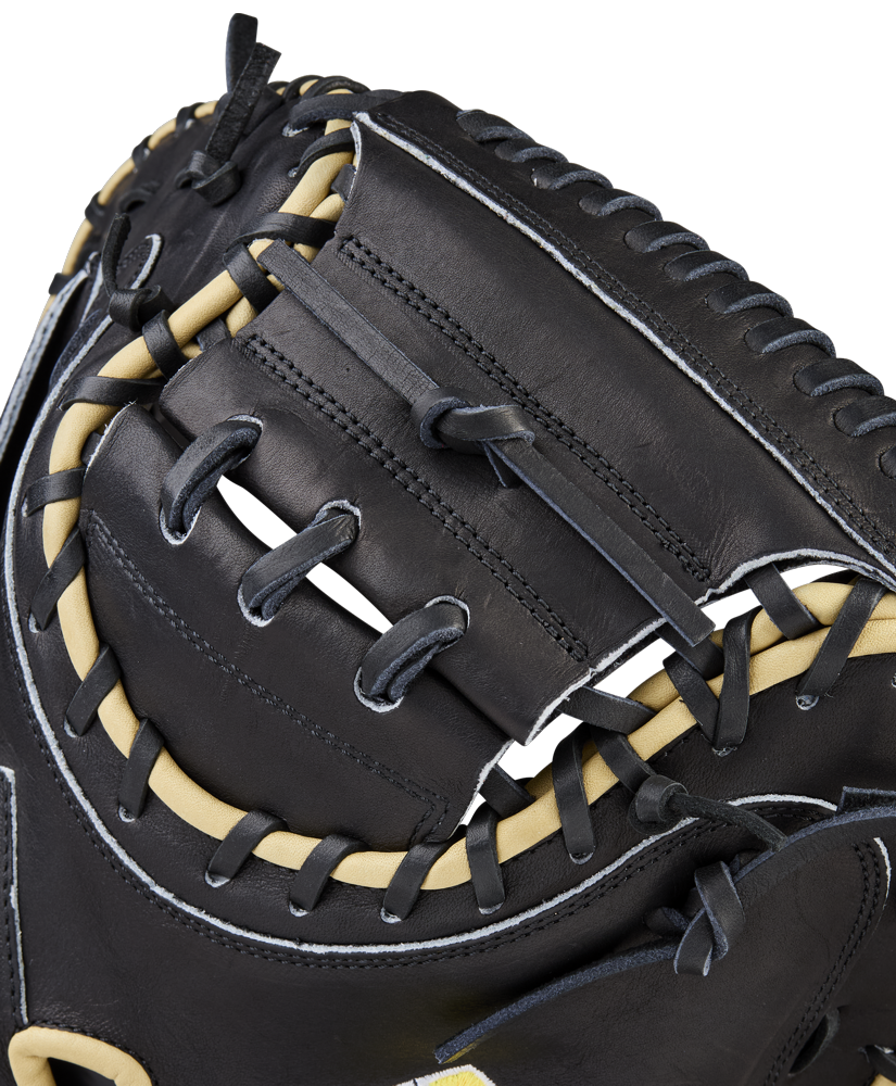 Close-up of the Wilson A2000 1734 34" Baseball Catcher's Mitt (WBW10412834), crafted from black Pro Stock Leather with tan laces and white stitching, highlighting its detailed craftsmanship and woven web.