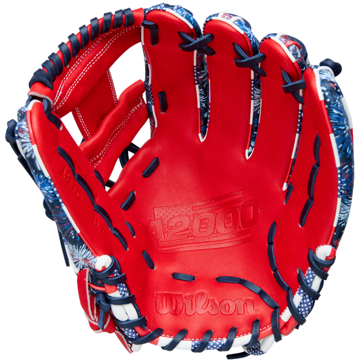 The Wilson A2000 1975SS 11.75" Baseball Glove (GOTM July 2025, WBW1042171175) features a red design with dark blue and white laces, blue and white accents, Pro Stock leather, and the A2000 logo embossed on the palm.