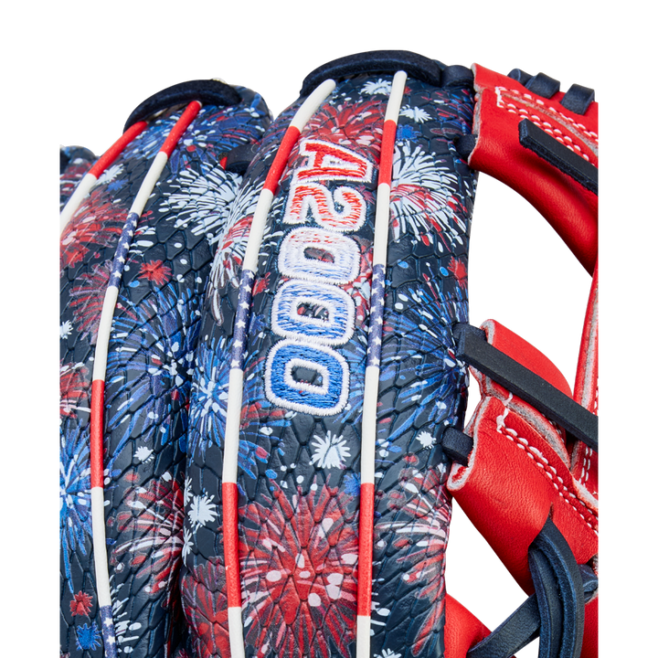Close-up of the Wilson A2000 1975SS 11.75" Baseball Glove (GOTM July 2025), featuring a red, white, and blue fireworks pattern, white laces, and "A2000" stitched in blue and white on the back.