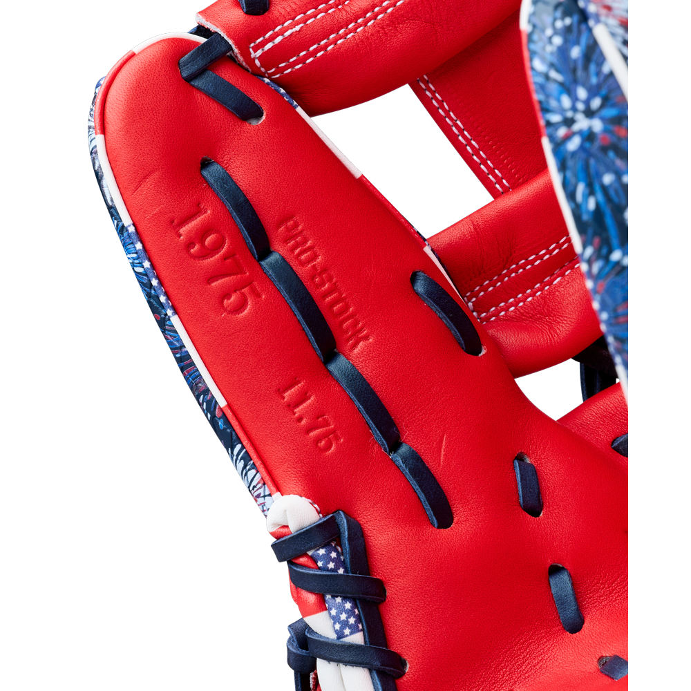 Close-up of the Wilson A2000 1975SS 11.75" Baseball Glove (GOTM July 2025) featuring red Pro Stock leather, navy blue and white laces, embossed "PROEDITION," "1975," and "11.75" on the inner palm, with patterned blue edges.