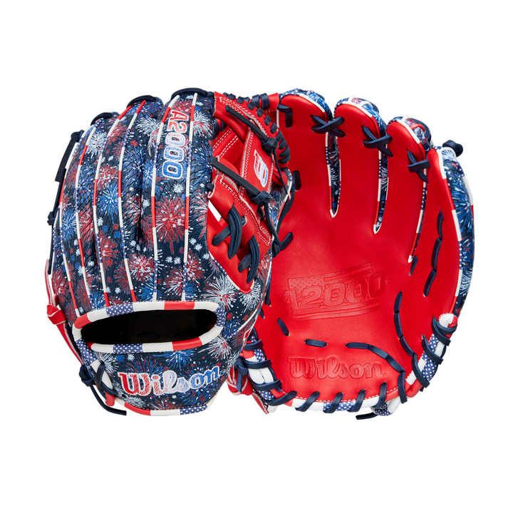 Two Wilson A2000 1975SS 11.75" Baseball Gloves (GOTM July 2025) with a red, white, and blue fireworks design and bright red Pro Stock leather lining are displayed against a white background.
