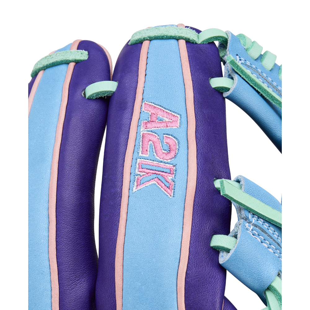 A close-up of the Wilson A2K 1720 11.5" Baseball Glove - GOTM October 2025 shows vibrant purple, teal, and pink accents with "A2K" stitched in pink, crafted from premium Pro Stock Select leather for elevated performance.