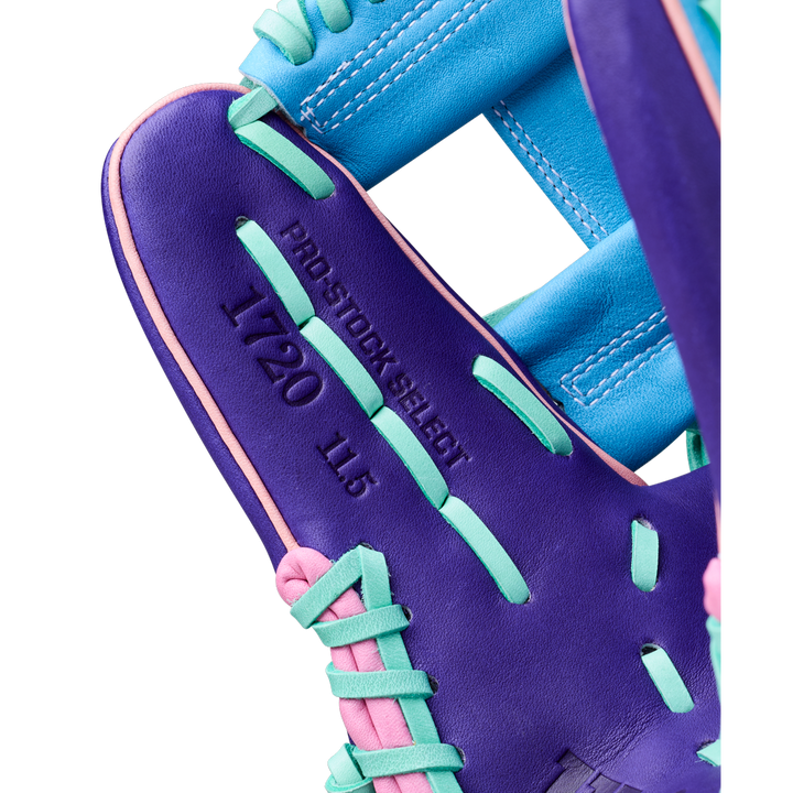 Close-up of a Wilson A2K 1720 11.5" GOTM October 2025 Baseball Glove, featuring purple with teal, blue, and pink laces. Crafted from Pro Stock Select leather, it's stamped PRO STOCK SELECT, 1720, and 11.5 on the palm.