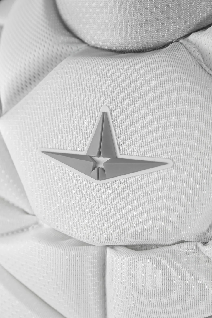 Close-up of the All Star PHX Paige Halstead Fastpitch Catcher's Chest Protector (CPW-PHX) in textured white fabric with a 3D gray star emblem—perfect for fastpitch catchers seeking Paige Halstead–inspired gear.