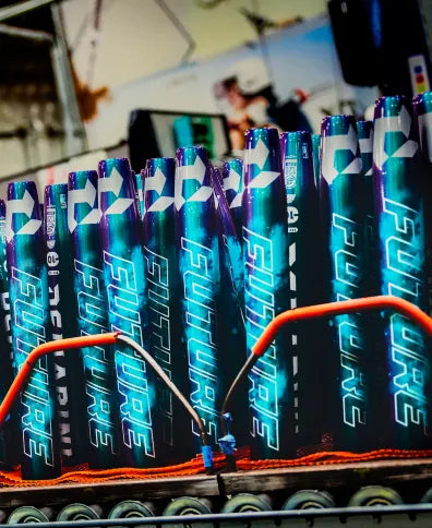 Close-up of metallic blue cans labeled FUTURE, stacked in rows with orange cables—evoking the bold design of the 2026 DeMarini Future (-10) Fastpitch Softball Bat: WBD2674010, known for its large sweet spot.