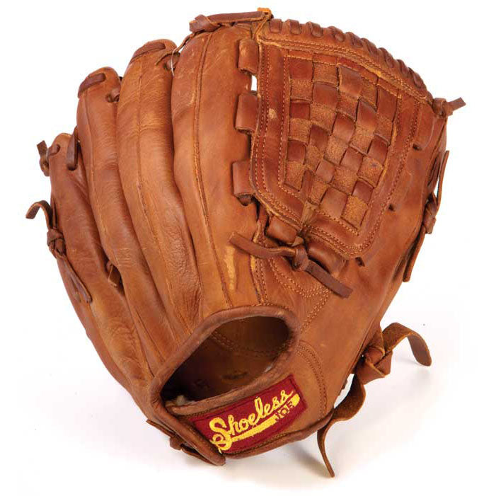 A worn 12" Shoeless Joe Baseball Glove (model 1200BW), made of brown Steerhide leather with visible stitching and a red and yellow "Shoeless Joe" label near the wrist opening.