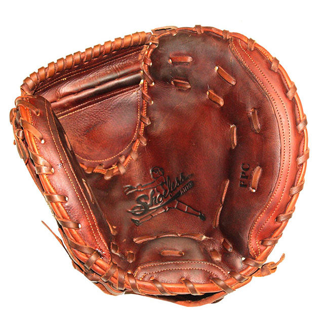 A worn brown leather Shoeless Joe 32" Fastpitch Catcher's Mitt (3200FPCM) with visible lacing and a logo featuring a player and the word “Shoeless,” designed in classic softball catcher’s mitt style.