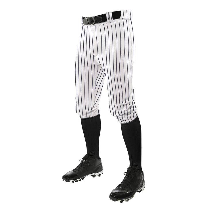 A person wears Champro Sports Triple Crown Pinstripe Knicker Baseball Pants (BPPINKA) in white with black pinstripes, a black belt, black knee-high socks, and cleatsâshown waist down on a white background.