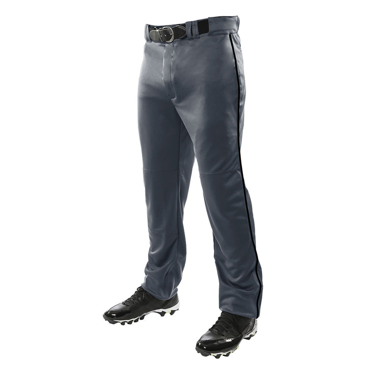 A person wearing Champro Sports Triple Crown Open Bottom Baseball Pants with Piping (BP91UA) in gray with black side piping, paired with a black belt and black cleats, stands against a white background.