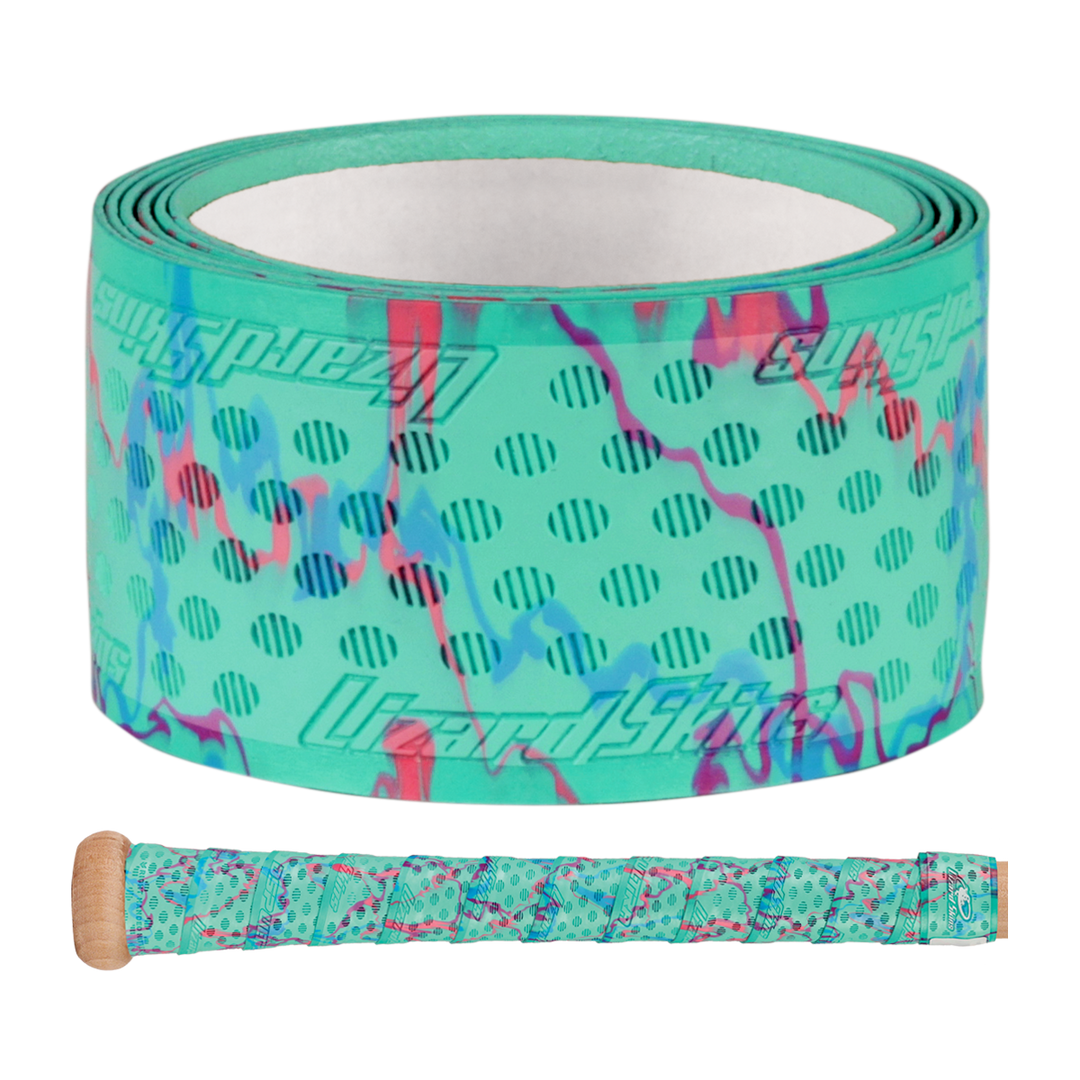 The Lizard Skins DSP Ultra Camo 1.1mm Bat Grip features turquoise polymer with purple and pink camo patterns, black polka dots, and branding. A sample shows the grip wrapped around a handle below the roll.