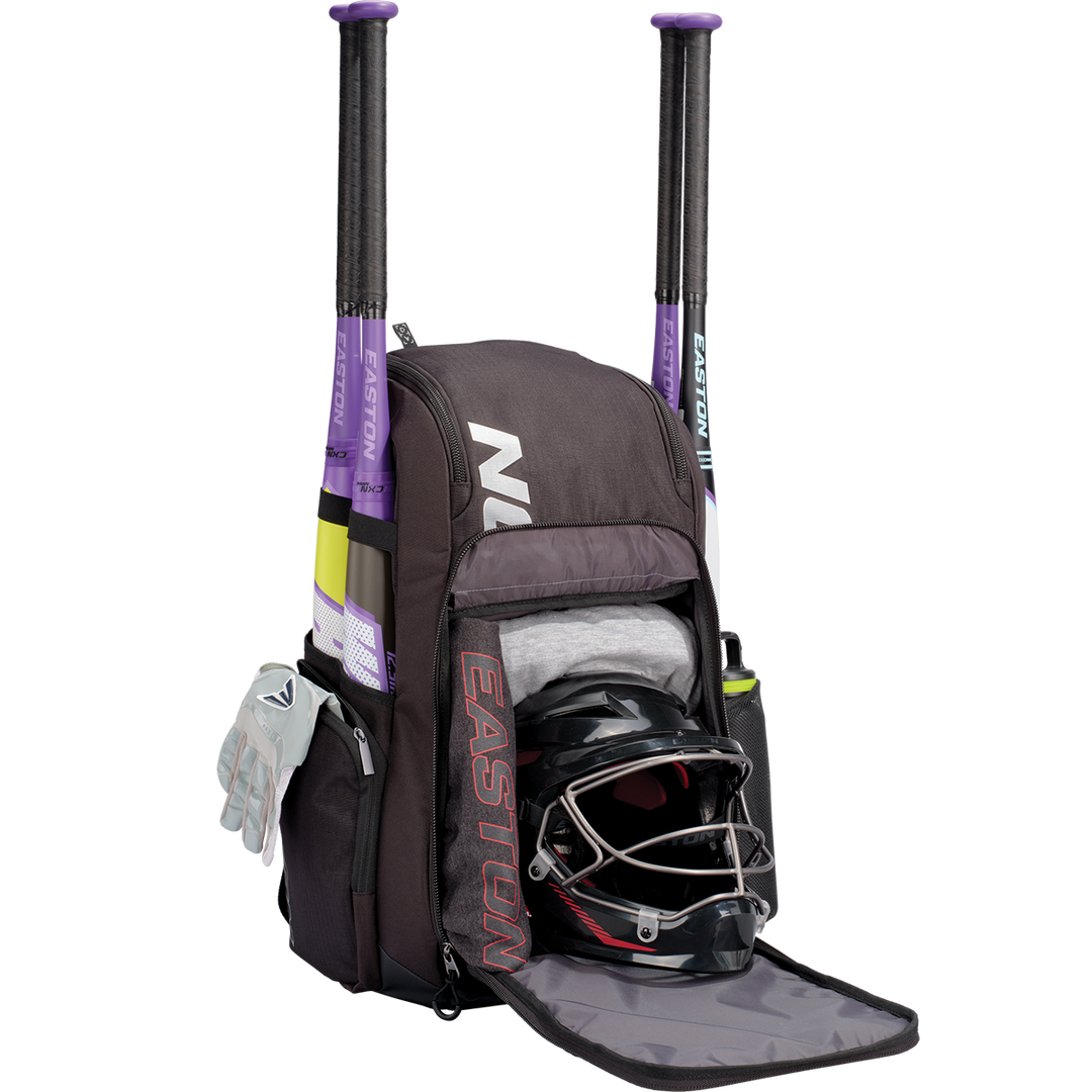 The Easton Roadhouse Backpack: EBA004 is shown in black, with two purple bats, gloves in the side pocket, a helmet with face guard, and a gray shirt in the main compartment—your perfect Easton slowpitch bat bag.