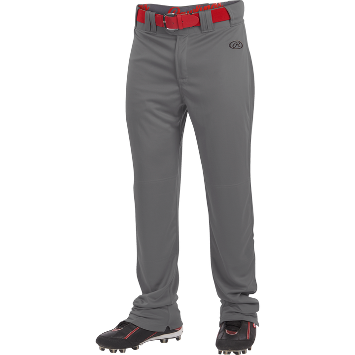 A person wearing Rawlings Adult Launch Semi-Relaxed Baseball Pants (LNCHSR) in gray, featuring a gel grip waistband, paired with a red belt and black cleats with red accents, shown from the waist down against a white background.