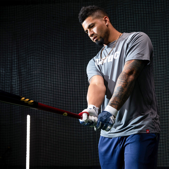 A man holding a Marucci GLEY25 Gleyber Torres Pro Model Maple Wood Bat (MVE2GLEY25-CH/BK) by Marucci.