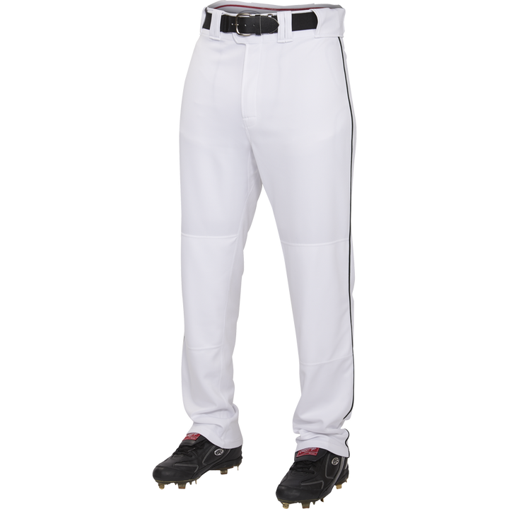 A person wears Rawlings Youth Premium Semi-Relaxed Baseball Pants with black piping (YPRO150P), a black belt, and black cleats, shown from the waist down against a plain white background.