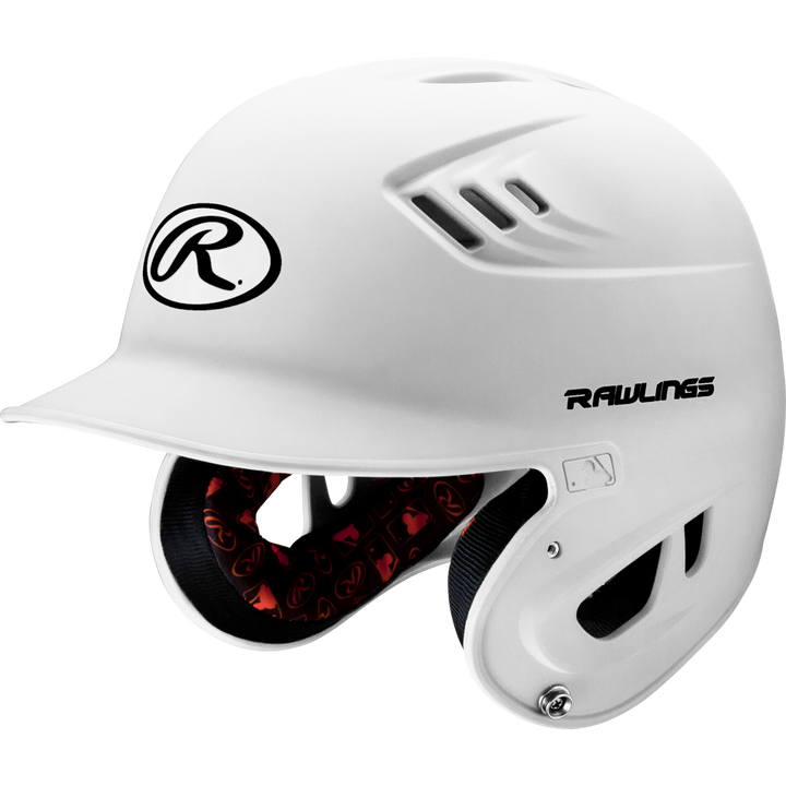 The Rawlings Velo Matte Batting Helmet: R16M features a white design with black logo, protective ear coverage, ventilation holes, and a red padded interior for safety and style in youth baseball.