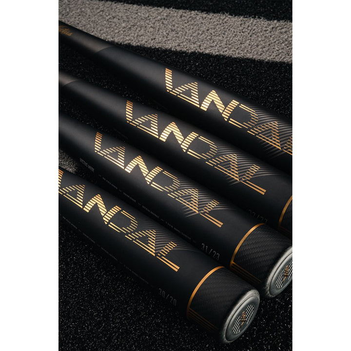 Three 2022 Victus Vandal 2 (-8) USSSA baseball bats from Victus, featuring "VANDAL" in gold, are lined up on a black and gray textured surface with their handles pointing away and barrels together in the foreground.