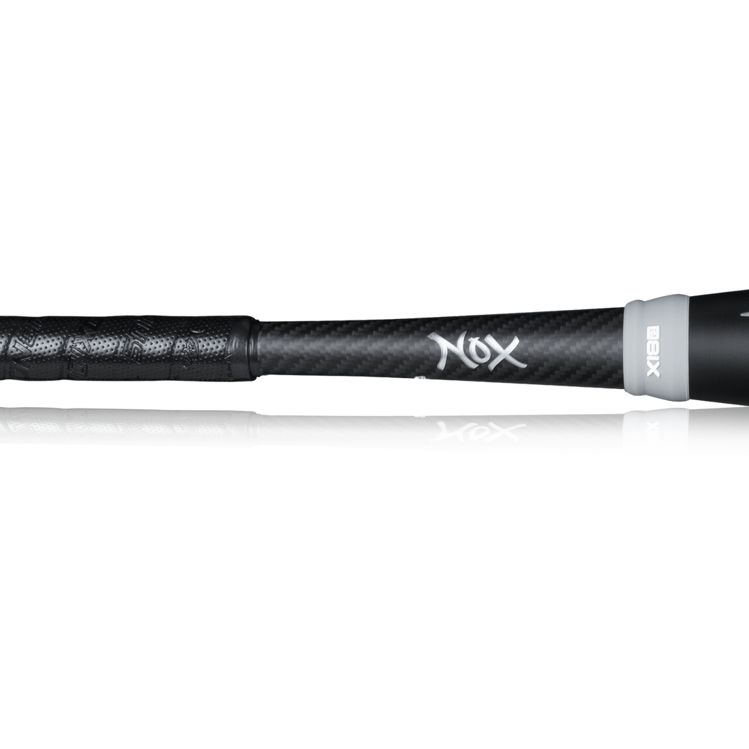 Close-up of the black handle and lower shaft on the 2023 Victus NOX 2 (-8) USSSA Baseball Bat, showing its textured grip and white NOX logo over a carbon fiber surface for improved control.