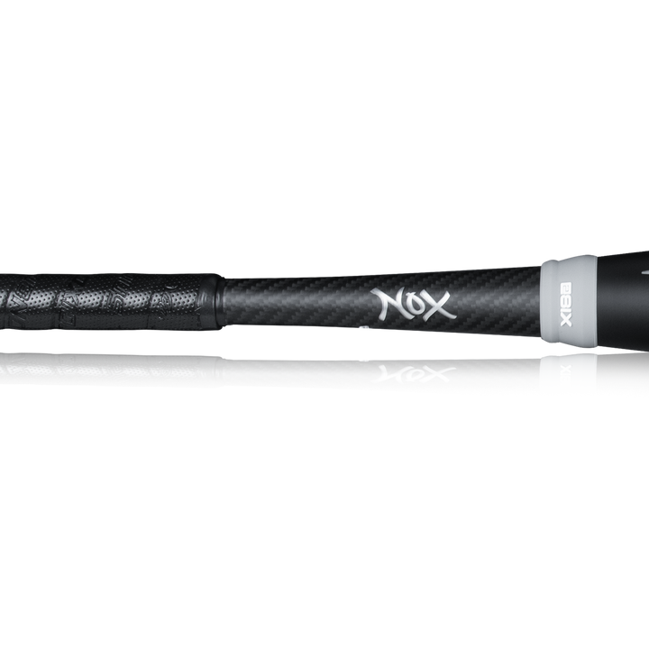 Close-up of the black handle and lower shaft on the 2023 Victus NOX 2 (-8) USSSA Baseball Bat, showing its textured grip and white NOX logo over a carbon fiber surface for improved control.