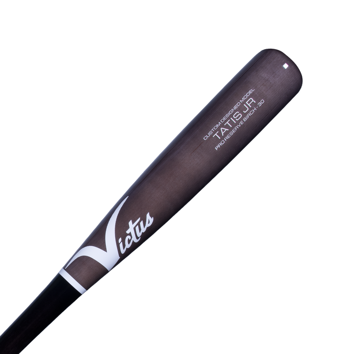 A close-up of the black and gray Victus TATIS JR Youth Pro Reserve Birch Wood Bat (VYRWBTATISJR) shows white script branding and model details printed near the barrel for a balanced feel.