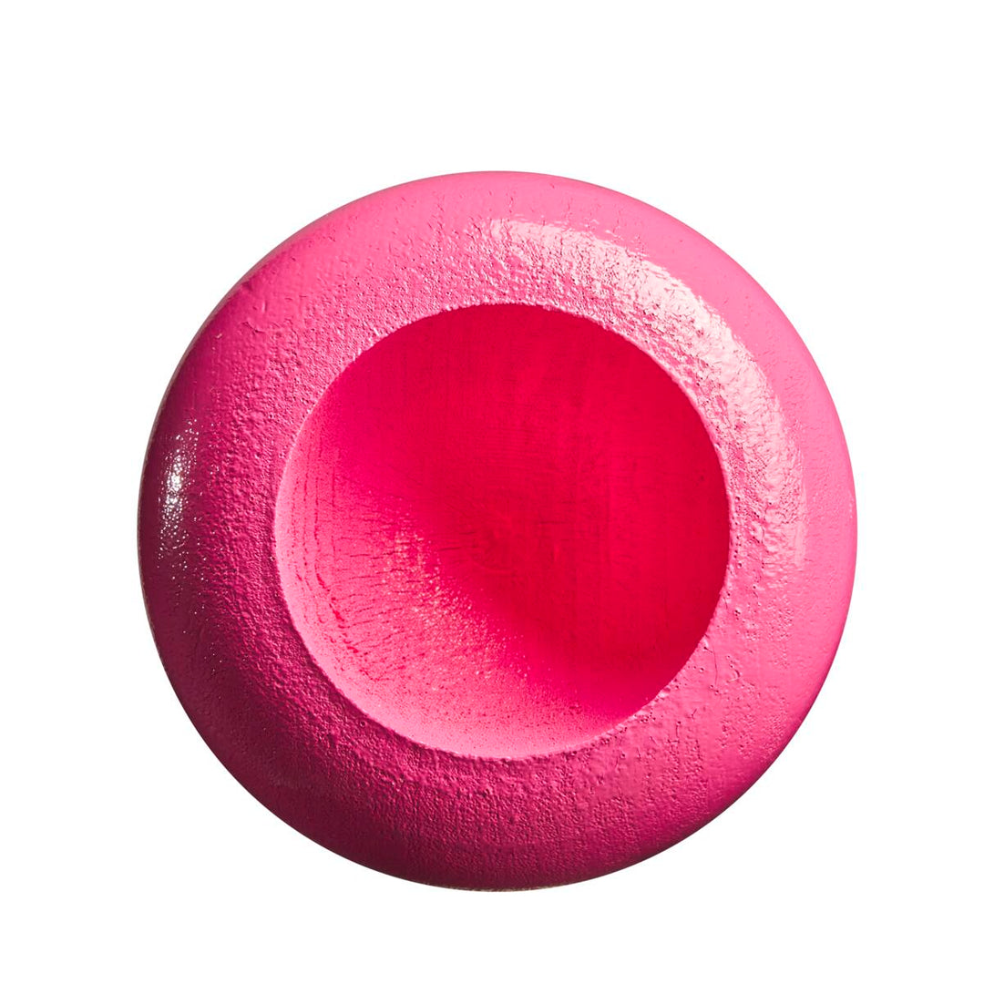 A bright pink, round object with a smooth center and textured edges, evocative of the balanced swing of the Louisville Slugger Genuine MIX Pink Wood Baseball Bat (WBL2691010), is photographed against a white background.