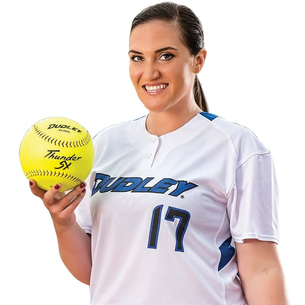 A woman wearing a white softball jersey with blue accents and the number 17 smiles while holding a Dudley 21" Trophy Autograph Softball (model 4D21AB) by Dudley in her right hand.