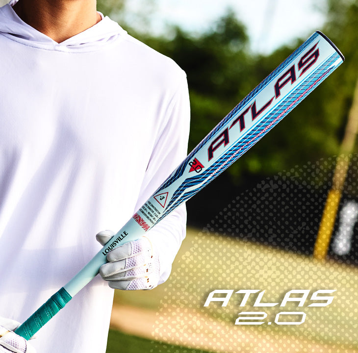 On the field, a baseball player in a white hoodie holds the Louisville Slugger 2027 Atlas 2.0 (-3) BBCOR Baseball Bat (WBL4248010), which showcases eye-catching blue, red, and white graphics. Crafted by Louisville Slugger with advanced EVX Alloy Technology for improved performance, this bat delivers a balanced swing weight for smooth and powerful hits. The “ATLAS 2.0” graphic is displayed in the bottom right corner of the image.