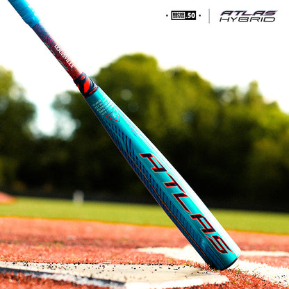 Close-up of the 2027 Louisville Slugger Atlas Hybrid (-3) BBCOR Baseball Bat: WBL4246010 with EVOKE Alloy Barrel on a dirt field, blurred green trees and grass in the background. Atlas Hybrid logo appears in the top right corner.